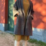 CHAMADE long coat sewing pattern photographed outdoors as a relaxed layering garment, emphasizing the dropped shoulder line and generous sleeves.