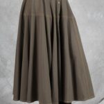 LOUISE flared button skirt sewing pattern: close-up of the khaki skirt showing its front buttons and full panelled shape.