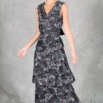 FOYS sewing pattern: fOYS floral maxi dress sewing pattern shown as the model walks, with the lower ruffle moving outward beneath the fitted waist and flared skirt.