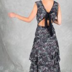 FOYS sewing pattern: back view of the FOYS maxi dress sewing pattern in floral fabric, featuring a V-shaped open back, oversized black bow and two ankle-length ruffled tiers.