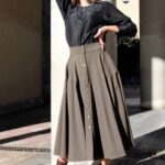 LOUISE circle skirt sewing pattern: finished look highlighting the hemline, skirt volume and how the garment hangs when worn. The sewn sample is olive green with a buttoned waist and a black top.