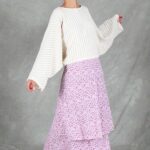 Front view of the BOHEME maxi skirt sewing pattern made in a small pink-and-lilac floral print, styled with an ivory blouse against a grey studio backdrop.