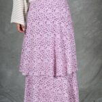 Close-up of the BOHEME maxi skirt sewing pattern in pink floral fabric, highlighting overlapping side ruffles and the drape from waist to hem.