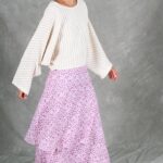 BOHEME maxi skirt sewing pattern photographed as the model turns, with pink printed ruffles spreading outward beneath a flowing white blouse.