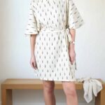 COSMOS batwing-sleeve tunic sewing pattern: wide integrated sleeves create the characteristic batwing outline. The look is designed for lightweight, flowing fabric.