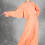 Coral version of the LOVY batwing sleeve dress sewing pattern, showing a flowing long skirt and relaxed sleeve shape.