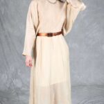 LOVY batwing sleeve maxi dress pattern, cream version with a slim dark belt, photographed with a hand lifted toward the face.
