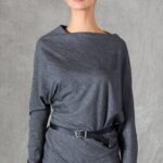 A model wearing a long sleeve top crafted with the TWYS top pattern. The top features a bias-cut design, offering a flattering drape and a comfortable fit. Styled with a belt to accentuate the waist, the look is paired with a textured white skirt, showcasing the top's versatility for both casual and elegant occasions.
