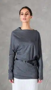 A model wearing a long sleeve top crafted with the TWYS top pattern. The top features a bias-cut design, offering a flattering drape and a comfortable fit. Styled with a belt to accentuate the waist, the look is paired with a textured white skirt, showcasing the top's versatility for both casual and elegant occasions.