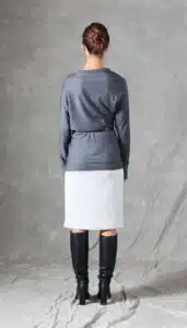 A model wearing a long sleeve top crafted with the TWYS top pattern. The top features a bias-cut design, offering a flattering drape and a comfortable fit. Styled with a belt to accentuate the waist, the look is paired with a textured white skirt, showcasing the top's versatility for both casual and elegant occasions.