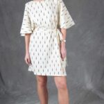 Model wearing a relaxed tunic made from the COSMOS sewing pattern: the optional belt changes a loose silhouette into a shaped one. The relaxed proportions favour ease of movement.
