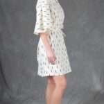 Model wearing a relaxed tunic made from the COSMOS sewing pattern: soft draping makes the tunic suitable for a relaxed outfit. The tunic can be styled with or without the tie.