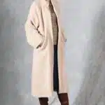 VIVIANE long beige women’s coat sewing pattern, photo showing a high-collar coat with button fastening and raglan sleeves.