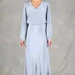 GIULIA sewing pattern: front view of the GIULIA bias-cut skirt sewing pattern in light blue, showing the waist beneath a matching blouse and the asymmetrical lower flounce.
