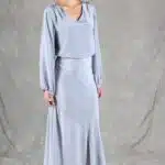 GIULIA sewing pattern: three-quarter front view of the GIULIA skirt sewing pattern with matching light-blue top, showing the smooth fit at the hips and flowing side ruffle.