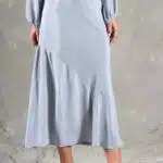 GIULIA sewing pattern: gIULIA bias-cut midi skirt sewing pattern in pale blue, shown from waist to ankle to highlight the diagonal flounce seam and gently flared hem.