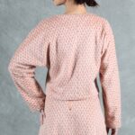 THAIS structured short jacket sewing pattern — final photograph in the numbered studio series emphasizing the minimal fitted-length hem and full upper-body sleeve volume.