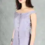IRIS button-front dress sewing pattern: three-quarter front studio view of a lilac dress with off-the-shoulder straps, fitted waist and soft fabric gathers.