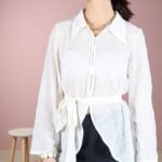 VOLATILE women’s shirt sewing pattern: embroidered white blouse design with hook-and-eye front closure, waist belt and fluid flared silhouette.