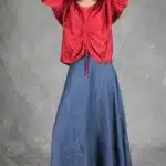 MAR gathered blouse sewing pattern: red top with ruched drawstring front and loose sleeves, model posing with arms raised.