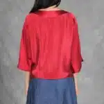 MAR women’s blouse sewing pattern: back view of the red loose-fitting top with elbow-length sleeves and blue maxi skirt.