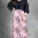 LORENA bias-cut maxi skirt sewing pattern: front view of the flowing pink spotted skirt styled with a black blouse.