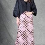 LORENA bias-cut skirt sewing pattern: three-quarter view of the pink spotted long skirt with a softly draped hem.