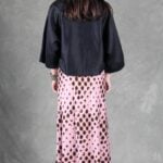 LORENA bias-cut skirt sewing pattern: back view of the long pink printed skirt styled with a black blouse.