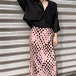LORENA bias-cut maxi skirt sewing pattern: pink animal-print long skirt with a black cropped blouse, photographed outdoors.