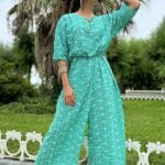 COLETTE women’s jumpsuit sewing pattern: flowing green wide-leg outfit worn on the street.