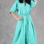 COLETTE jumpsuit sewing pattern: green wide-leg jumpsuit with soft waist pleats and relaxed kimono-style sleeves.