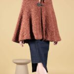 CAYS women’s cape sewing pattern, a versatile cape design with a rounded collar and decorative clasp closure.