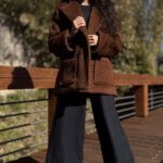 Lifestyle image of the STELLA oversized jacket sewing pattern, styled as a coordinated look. The long lapels and simple buttoned front draw attention to the jacket’s relaxed silhouette.