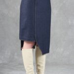 Close-up of the JANYS asymmetric skirt sewing pattern, showing the fitted dark pencil skirt, overlapping front panel and uneven hem.