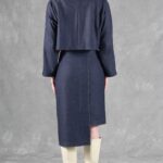 Back view of the JANYS pencil skirt sewing pattern, showing the navy skirt’s back seam, asymmetric hem and matching cropped jacket.