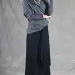 LE SILENCE DU VENT asymmetric skirt-over-pants sewing pattern: three-quarter view of black wide-leg trousers and the draped front layer.