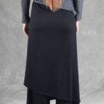 Close back view of the LE SILENCE DU VENT sewing pattern: black draped skirt panel layered over wide-leg pants.