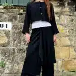 LE SILENCE DU VENT pants with skirt sewing pattern, photograph of the finished statement outfit combining flowing wide trousers with an asymmetrical wrap-like overlay.