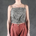 MILA summer tank top sewing pattern for women: an airy sleeveless blouse with soft under-bust gathers, crossed back panels and an adjustable waist tie.