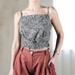 MILA sleeveless summer top sewing pattern for beginners, showing the relaxed blouse design with crossed back, soft gathers and waist ties.