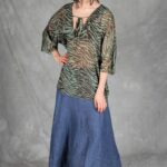 Model wearing a loose SOL tunic made from an easy tunic sewing pattern, styled with a skirt. The relaxed top has a flattering V neckline and Japanese sleeves that flow directly from the bodice.