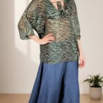 Presentation image for the SOL women’s tunic sewing pattern, showing the easy-to-wear top with a V neck, loose silhouette and wide Japanese-style sleeves, suitable for a relaxed skirt outfit.