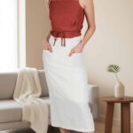 CHARLIZE midi skirt sewing pattern cover for women, showcasing the straight high-waisted skirt design with front patch pockets.