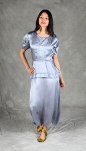 Vintage-inspired silver satin dress featuring front pintucks and peplum detail, sewn using a flair dress sewing pattern.