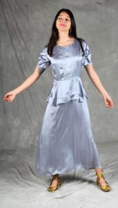 Elegant handmade dress with short puff sleeves, shiny satin fabric, and peplum silhouette, created from an elegant dress sewing pattern
