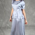 Retro-style silver dress with a flowing shape, structured bodice, and peplum design, made with a vintage-style dress sewing pattern.