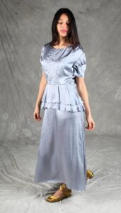 Retro-style silver dress with a flowing shape, structured bodice, and peplum design, made with a vintage-style dress sewing pattern.