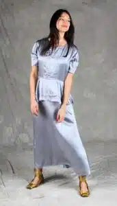 Elegant and flowing silver satin dress with a peplum detail and soft puff sleeves, made from a summer dress sewing pattern