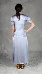 Sophisticated silver event dress with retro-inspired pintuck bodice and layered peplum, made with an event dress sewing pattern