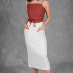 CHARLIZE midi skirt sewing pattern: three-quarter view of a white high-waisted skirt with front patch pockets.